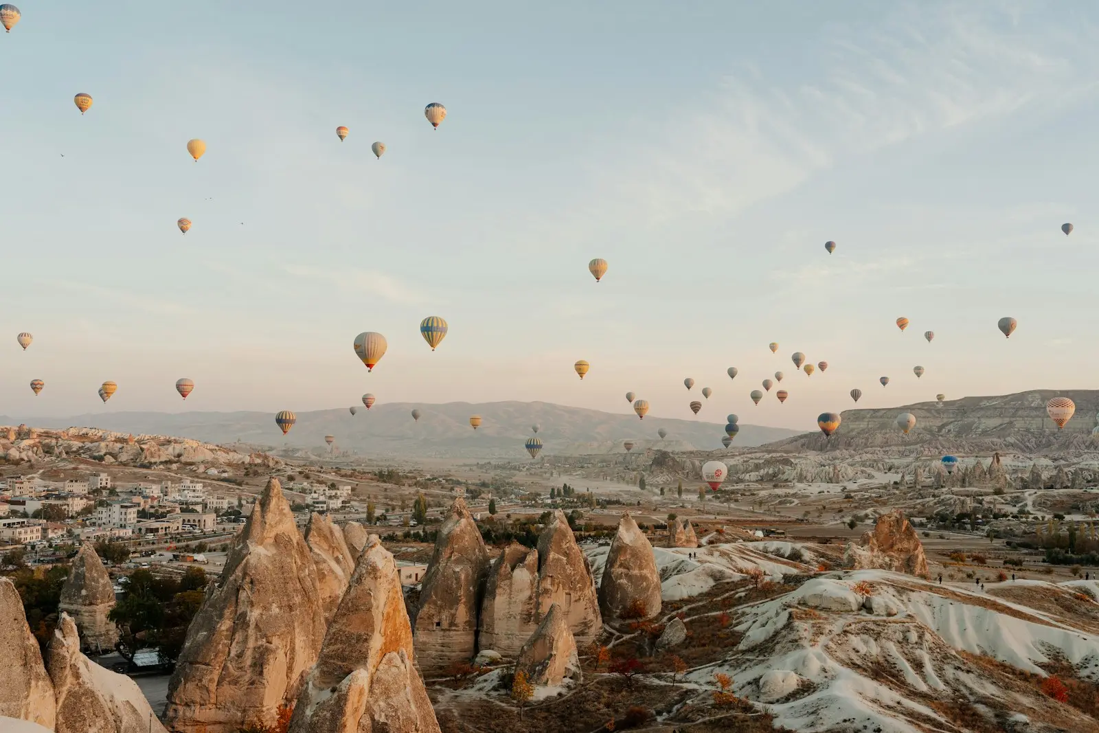 Hot air balloons floating over Cappadocia's valleys