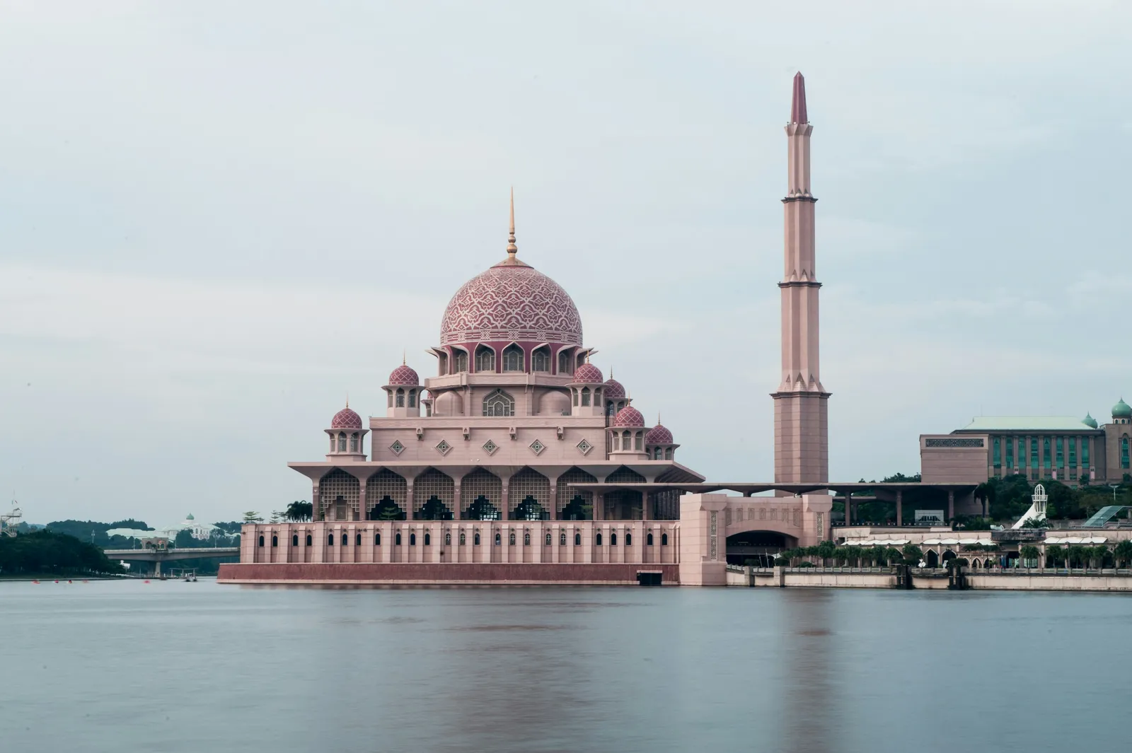 The pink dome of Putra Mosque beside the lake in Putrajaya
